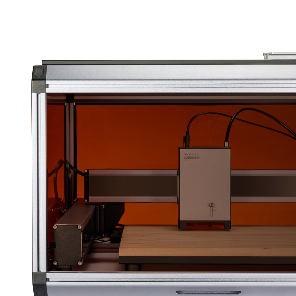 Close-up view of the Snapmaker Ray enclosure's interior, with a laser module installed and prepared for engraving tasks.