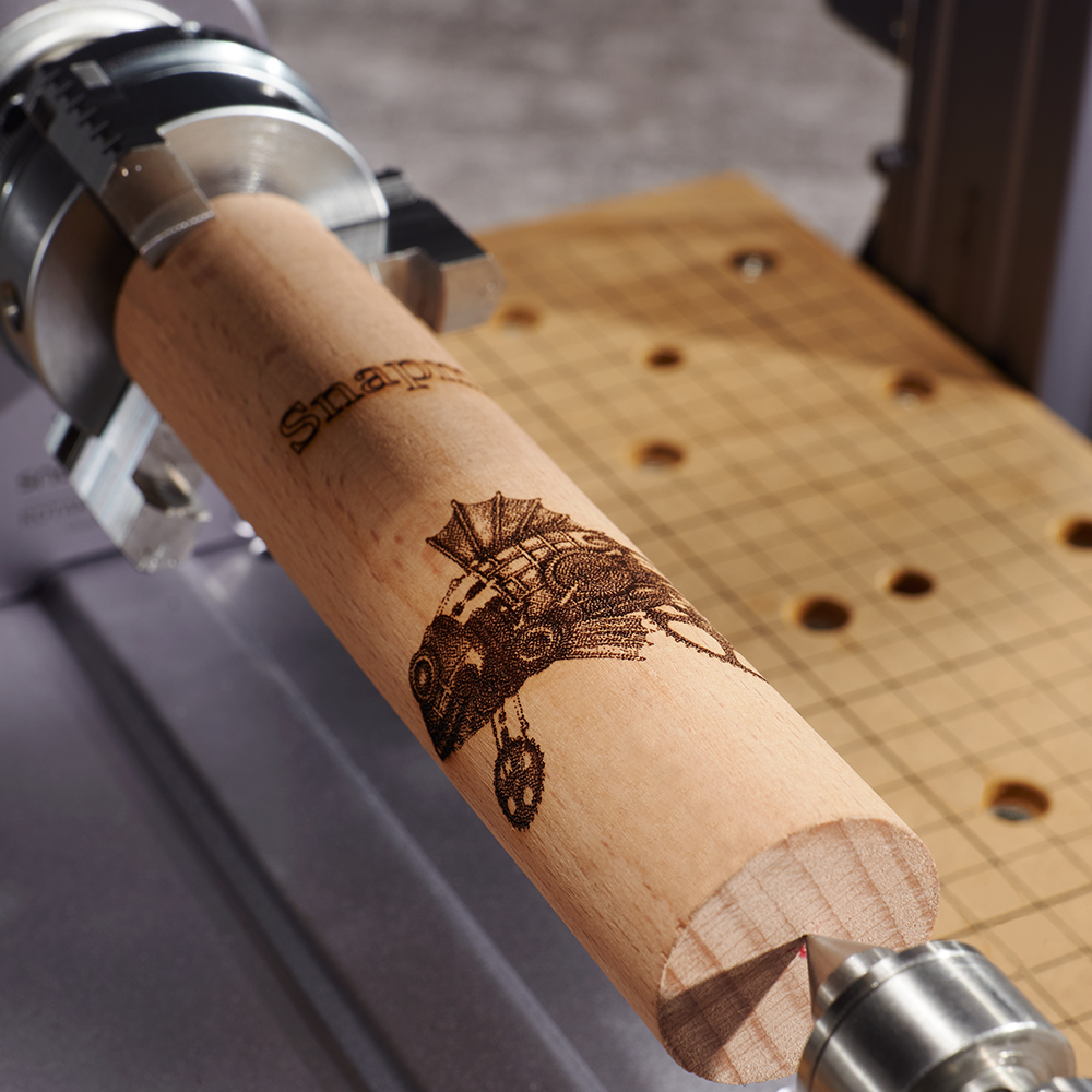 Detailed CNC and laser engraving on wood using Snapmaker Rotary Module.